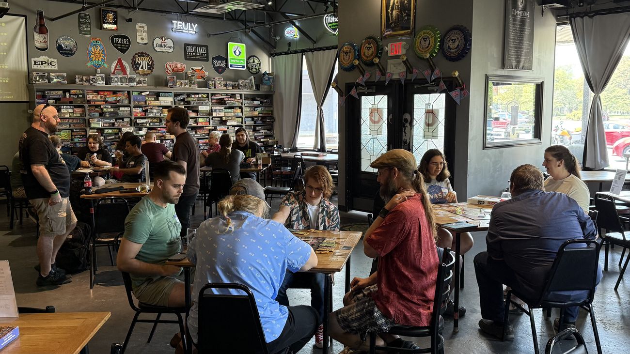 A busy board-game bar full of people at a Join Dayton meetup