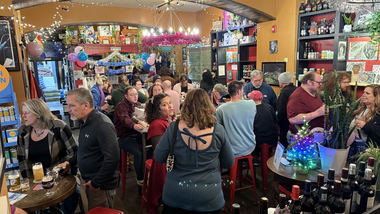 A crowd mingling at a bottle shop for a Join Dayton meetup