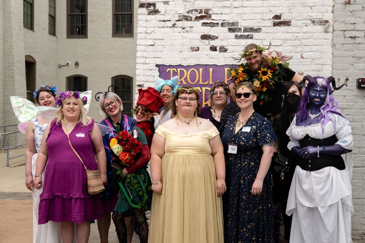 Costumed attendees posing together outside a Join Dayton meetup