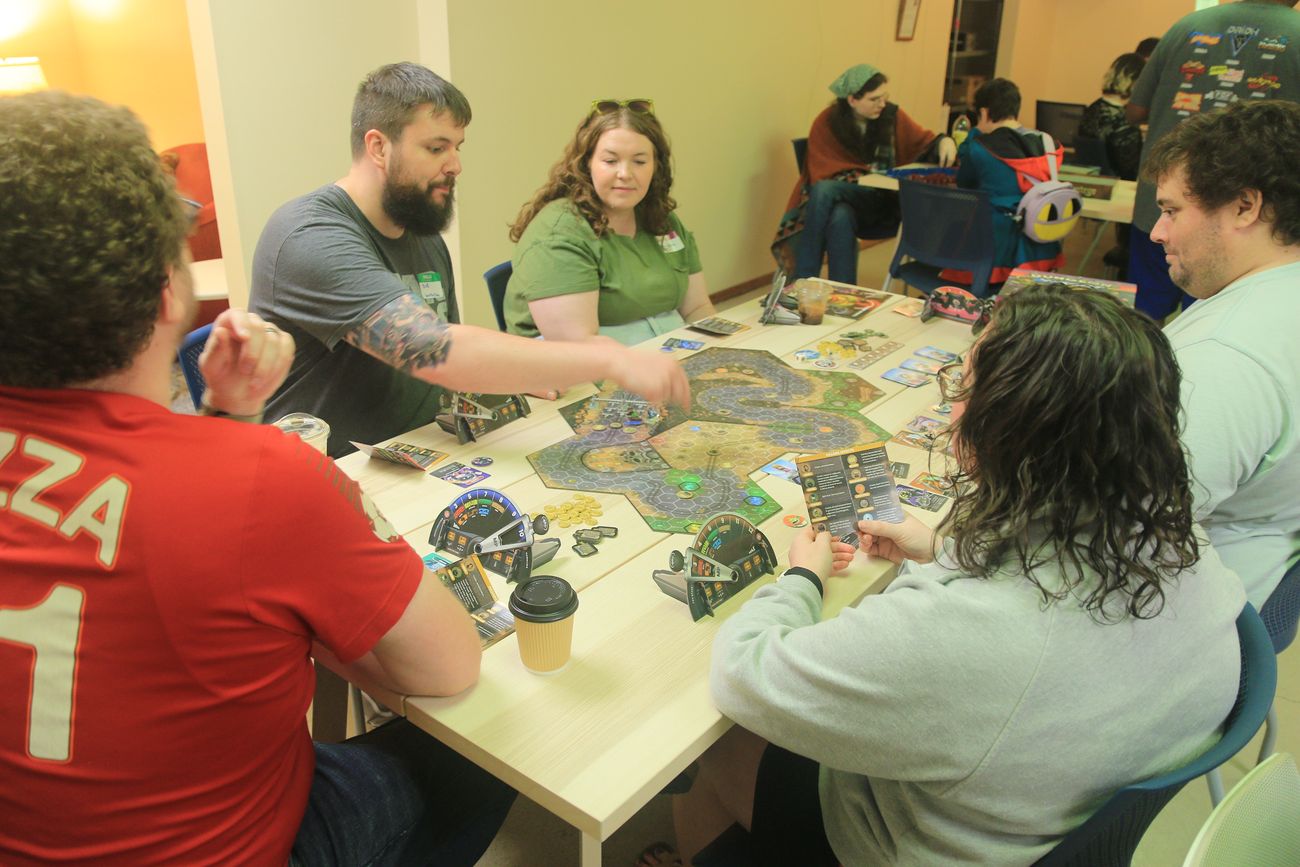 Friends playing a board game at a Join Dayton meetup