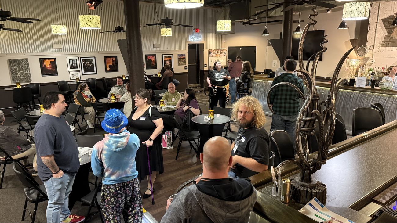 People talking and mingling at an evening Join Dayton meetup