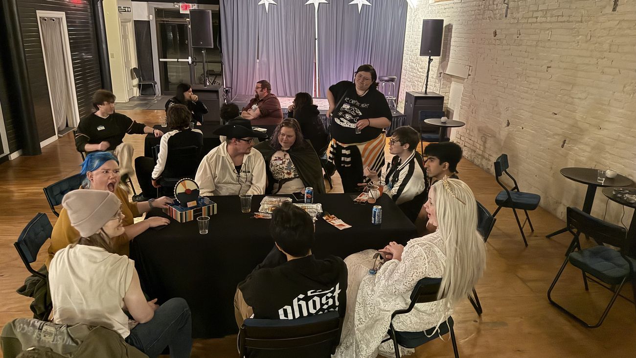 A table of people at a night-time Join Dayton meetup